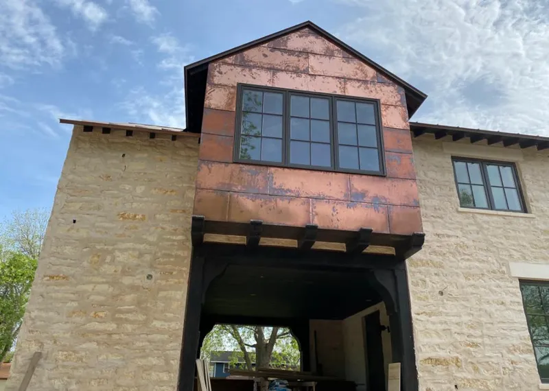Copper metal panel facade on a stone building for Skylight Installation in Canyon Lake