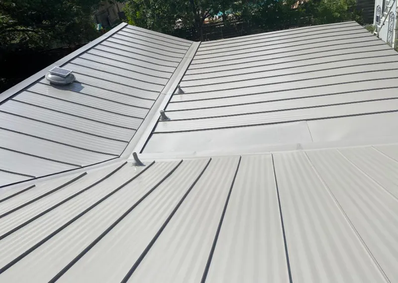 Solar attic fan installed on a metal roof for Roof Ventilation in Canyon Lake