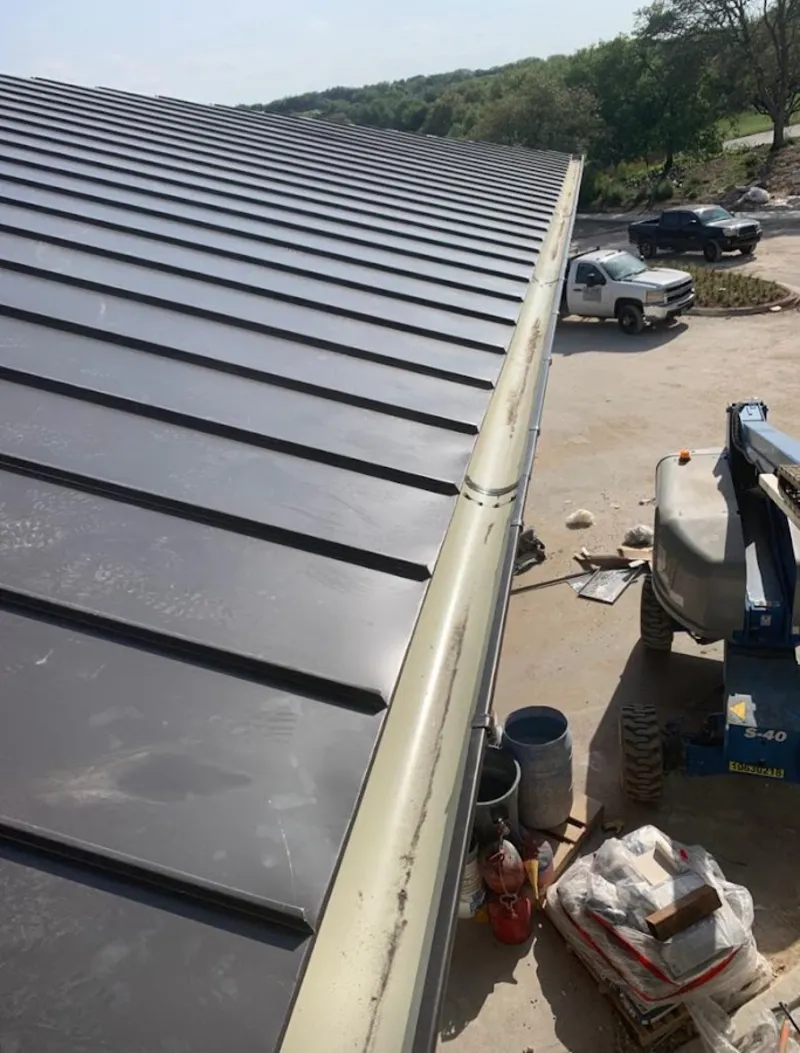Standing seam panel and gutter detail on a metal roofing jobsite in Canyon Lake